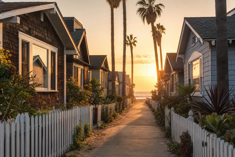 Craftsman beach cottages on a narrow palm-lined lane in Pierpont, Ventura