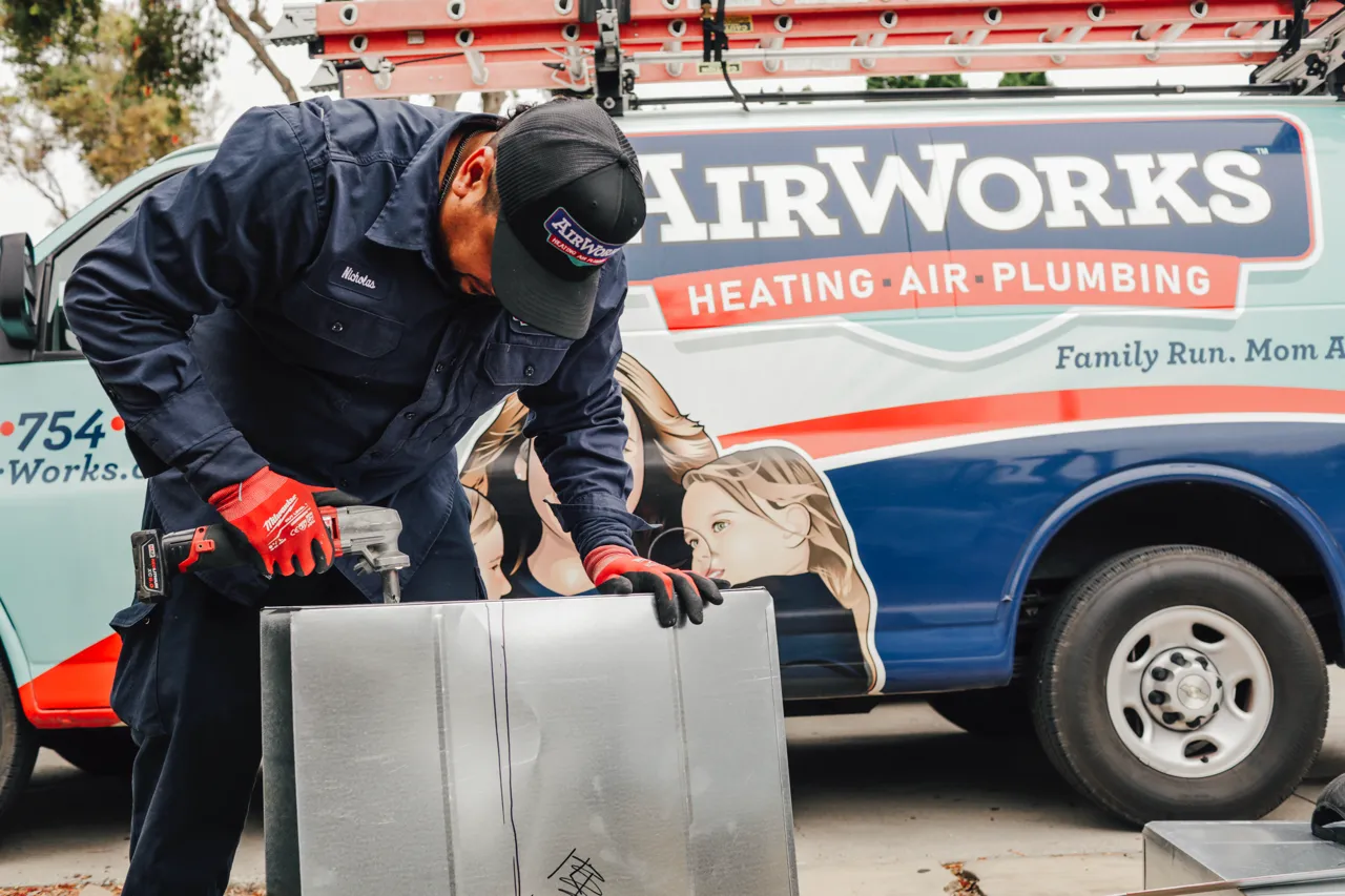 AirWorks technician working on a residential heating system