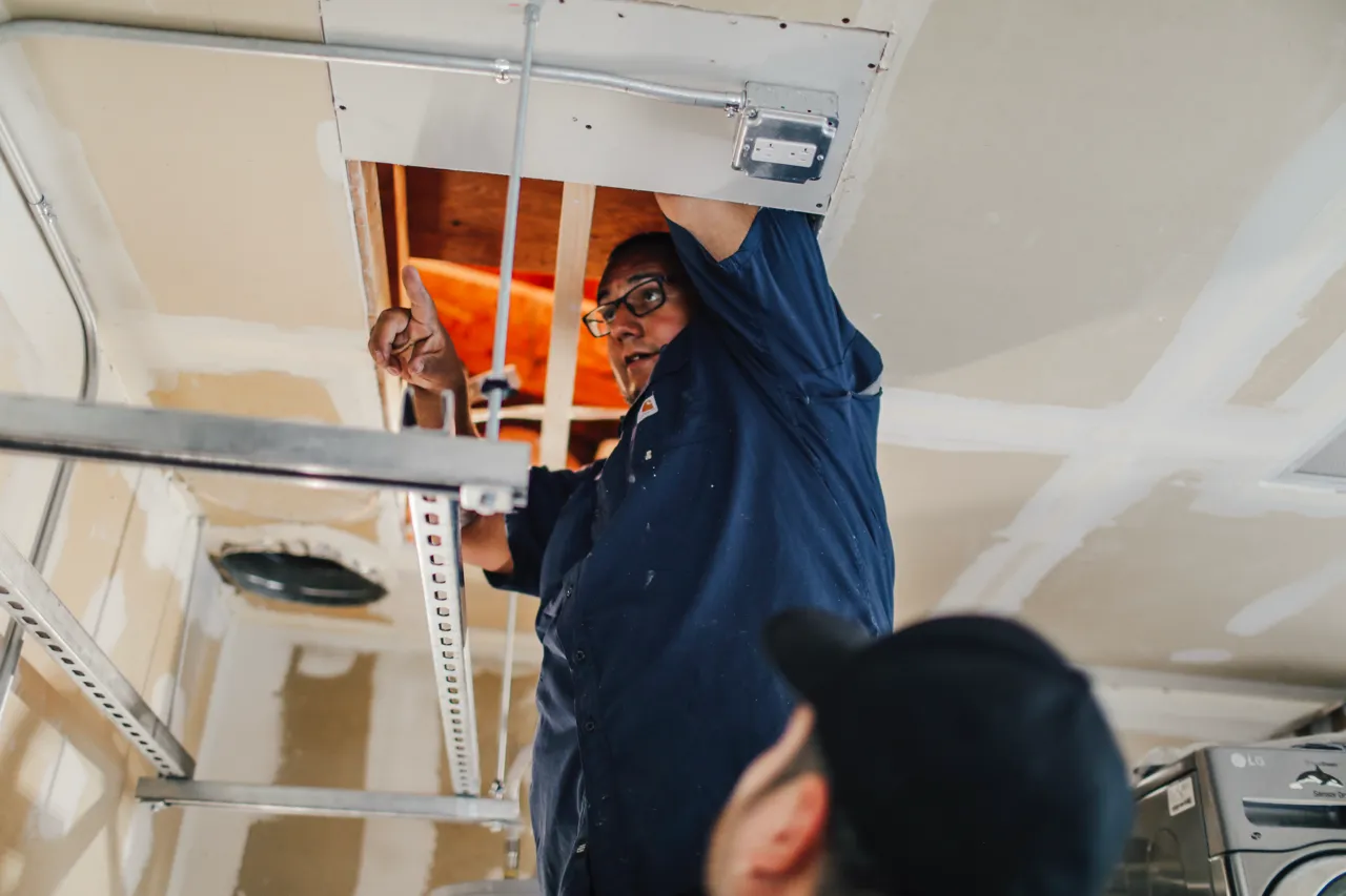 AirWorks technician installing indoor air quality equipment